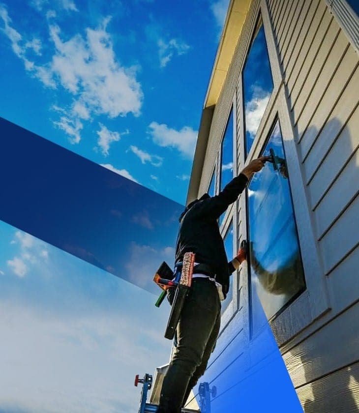 RiseClear technician performing professional window cleaning in Winnipeg
